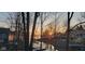 Lake view showcasing the tranquil water at sunset, framed by surrounding trees, creating a peaceful ambiance at 448 Tamarack Ln, Noblesville, IN 46062