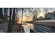 Breathtaking lake view featuring a waterfront property, enveloped by lush trees and a serene sunset backdrop at 448 Tamarack Ln, Noblesville, IN 46062