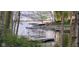 Scenic lake view showing a boat dock surrounded by lush trees, perfect for relaxing and enjoying the scenery at 448 Tamarack Ln, Noblesville, IN 46062