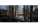 Waterfront property featuring a tranquil view of the lake from the deck, surrounded by lush trees at 448 Tamarack Ln, Noblesville, IN 46062