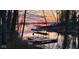 Sunset over the lake highlighting a property with boat docks and a serene, tree-lined waterfront view at 448 Tamarack Ln, Noblesville, IN 46062