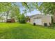 Expansive backyard with lush greenery, a storage shed, and a detached garage at 4510 Gadsden St, Indianapolis, IN 46241