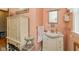 A stylish bathroom with a vanity, mirror, and coordinated decor in pink at 4510 Gadsden St, Indianapolis, IN 46241