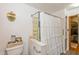 Modest bathroom with shower, toilet, and storage; featuring a shower curtain at 4510 Gadsden St, Indianapolis, IN 46241