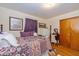 Charming bedroom featuring a decorative bedspread, purple accents, and hardwood floors at 4510 Gadsden St, Indianapolis, IN 46241