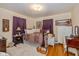 A cozy bedroom featuring a decorative quilt, wood floors, and purple curtains at 4510 Gadsden St, Indianapolis, IN 46241