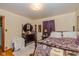 Comfortable bedroom with wooden furniture, a floral bedspread, and soft natural lighting at 4510 Gadsden St, Indianapolis, IN 46241