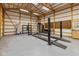 Spacious garage featuring a four-post vehicle lift, cabinets, peg boards, and bright lighting at 4510 Gadsden St, Indianapolis, IN 46241