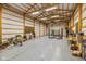Large open garage with tall ceilings, ample storage space, bright lighting, and a four post vehicle lift at 4510 Gadsden St, Indianapolis, IN 46241