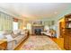 Cozy living room featuring a brick fireplace, hardwood floors, and ample natural light at 4510 Gadsden St, Indianapolis, IN 46241
