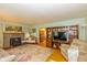 Bright living room featuring a brick fireplace, hardwood floors, and built-in shelving at 4510 Gadsden St, Indianapolis, IN 46241
