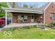 Comfortable covered porch with furniture, perfect for relaxing outdoors with mature green front yard at 4510 Gadsden St, Indianapolis, IN 46241