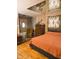 Bedroom with a mirror ceiling, wooden floors, and a comfortable bed at 4820 Nowland Ave, Indianapolis, IN 46201