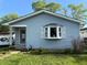 Charming one-story home featuring light blue siding, a bay window, and a well-maintained front lawn at 4820 Nowland Ave, Indianapolis, IN 46201