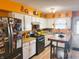 Well-equipped kitchen with orange walls, white cabinets, and modern appliances at 4820 Nowland Ave, Indianapolis, IN 46201