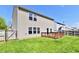 Beautiful backyard featuring a wooden deck, well-maintained lawn, and privacy fencing at 5005 Whisenand Dr, Indianapolis, IN 46254