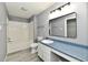Bathroom with a tub and shower, and a sink with a blue countertop at 5005 Whisenand Dr, Indianapolis, IN 46254