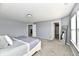 Inviting bedroom with soft carpet, bright natural light, and adjacent bathroom and closet at 5005 Whisenand Dr, Indianapolis, IN 46254