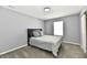 Cozy bedroom featuring a bed with grey bedding, carpet, and a bright window at 5005 Whisenand Dr, Indianapolis, IN 46254