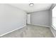 Spacious bedroom featuring gray walls, carpet, and a window for natural light at 5005 Whisenand Dr, Indianapolis, IN 46254