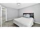 Comfortable bedroom featuring a view into another room, carpet, and a bright window at 5005 Whisenand Dr, Indianapolis, IN 46254