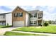 Lovely home showcasing a well-maintained lawn and beautiful architecture with a two-car garage at 5005 Whisenand Dr, Indianapolis, IN 46254