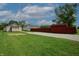 The backyard features lush grass, a gravel driveway, and a storage shed at 52 N Ross St, Columbus, IN 47201