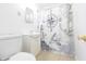 Small bathroom with white toilet, sink, mirror, and nautical themed shower curtain at 52 N Ross St, Columbus, IN 47201