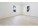 Bedroom featuring large windows and neutral tile flooring at 52 N Ross St, Columbus, IN 47201