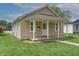 Welcoming single-story home with covered porch and well-kept lawn at 52 N Ross St, Columbus, IN 47201