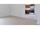 Open concept living area with neutral tile floors leading to kitchen at 52 N Ross St, Columbus, IN 47201