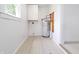 Utility room with tile flooring, hot water tank, and built-in wall cabinet at 52 N Ross St, Columbus, IN 47201