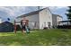 Large backyard with playground, shed, patio with furniture, and fire pit, perfect for outdoor entertaining at 562 Harmony Dr, Greenwood, IN 46143