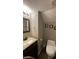 Compact bathroom featuring a modern vanity and efficient toilet design at 562 Harmony Dr, Greenwood, IN 46143