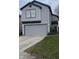 Charming two-story home with a gray vinyl siding and a two car garage at 562 Harmony Dr, Greenwood, IN 46143
