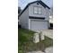 Charming two-story home with gray vinyl siding, complemented by a well-maintained lawn at 562 Harmony Dr, Greenwood, IN 46143