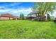 Lush backyard with expansive lawn, mature trees, black fencing, and a screened-in porch at 5942 Tioga Ct, Bargersville, IN 46106