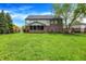 Spacious backyard featuring lush lawn, mature trees, black metal fencing, and a screened-in porch at 5942 Tioga Ct, Bargersville, IN 46106