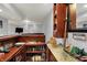 Basement wet bar with wooden cabinetry, granite countertops, barware, and other unique design elements at 5942 Tioga Ct, Bargersville, IN 46106