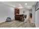 Finished basement featuring a stylish wooden bar with seating and modern lighting at 5942 Tioga Ct, Bargersville, IN 46106