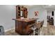 Basement bar with wooden bar, barstools, shelving and decorative sports memorabilia at 5942 Tioga Ct, Bargersville, IN 46106