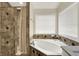 Elegant bathroom with a luxurious tub and tiled shower at 5942 Tioga Ct, Bargersville, IN 46106