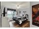 Bedroom featuring a black bed frame, ceiling fan, and a large window overlooking the greenery outside at 5942 Tioga Ct, Bargersville, IN 46106