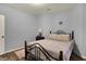 Comfortable bedroom with wrought iron bed frame, wood floors, and soft, neutral decor at 5942 Tioga Ct, Bargersville, IN 46106
