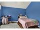 A blue bedroom featuring a bed, desk, and whimsical butterfly decorations at 5942 Tioga Ct, Bargersville, IN 46106