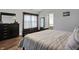 Bright bedroom featuring wood-look floors, a dresser, and a bathroom doorway at 5942 Tioga Ct, Bargersville, IN 46106