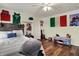 Inviting bedroom with wood floors, a ceiling fan, and decorative elements, providing a comfortable and stylish living space at 5942 Tioga Ct, Bargersville, IN 46106