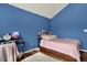 Cozy bedroom featuring blue walls, wood floors, and a comfortable bed, creating a relaxing and inviting atmosphere at 5942 Tioga Ct, Bargersville, IN 46106