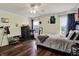 Bright bedroom featuring hardwood floors, a ceiling fan, and ample natural light, creating a comfortable and inviting atmosphere at 5942 Tioga Ct, Bargersville, IN 46106