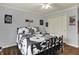 Bedroom with black metal bedframe, ceiling fan, light grey walls, and white closet doors at 5942 Tioga Ct, Bargersville, IN 46106